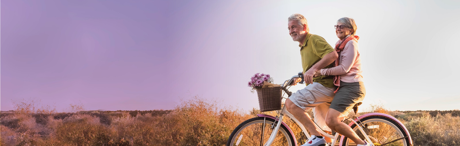 elderly couple riding on tandem bicycle